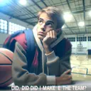 Generate an image that represents the scene of a young individual, looking hopeful and nervously waiting for a response. The individual could be standing in an indoor setting like a gym, their appearance reflecting the feeling of anticipation. Include visual elements like a basketball court or a sports gear to suggest the context of the question 'Did, did I make the team?'. Remember, the image should not contain any text.